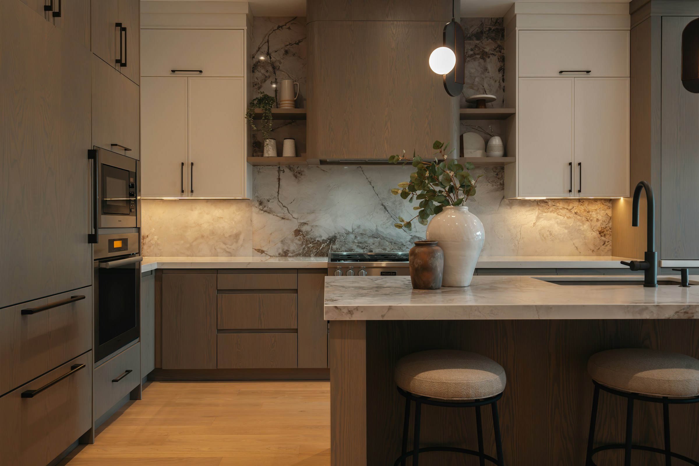 Warm greige kitchen with timber cabinetry and expressive stone