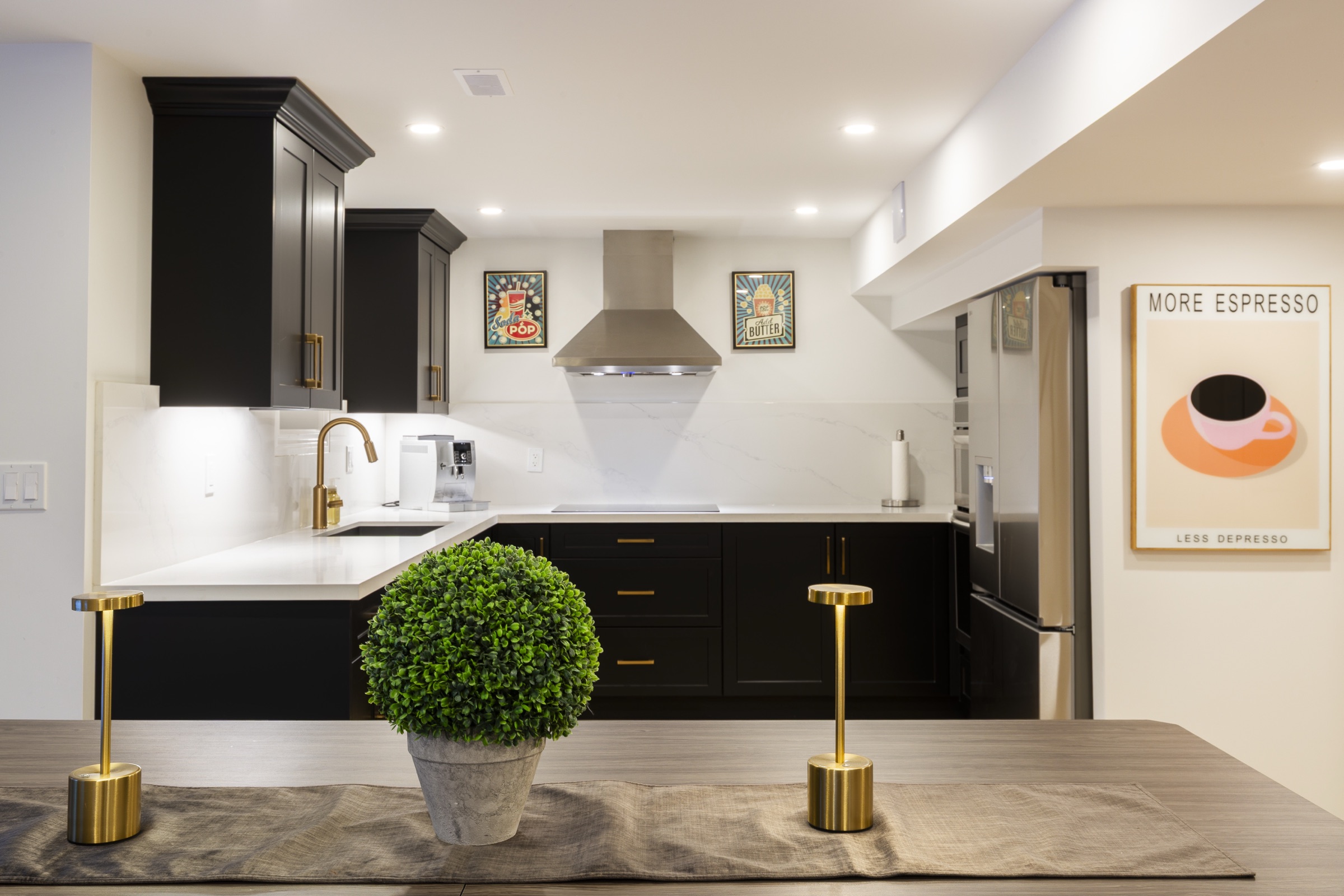 Dark framed kitchen with warm hardware